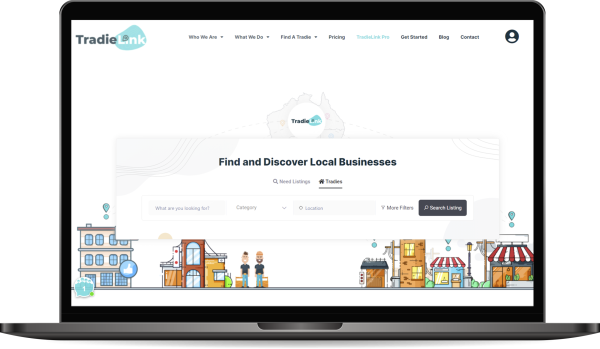 The TradieLink laptop screen showcases a webpage with a search bar labeled "Find and Discover Local Businesses." Illustrated shops, buildings, and business icons enhance the scene. The navigation menu features easy access to "Who We Are" and "Pricing" sections.